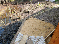 The path as it turns the corner at the back of the cabin